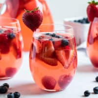 square image of summer berry sangria in a stemless wine glass
