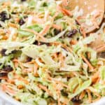 square close up image of summer coleslaw in a white serving bowl