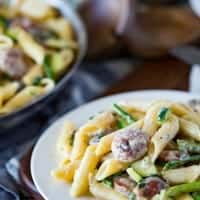 A creamy, flavorful cream sauce, a top penne, with summer sausages and your favorite green summer vegetables. This CREAMY SUMMER VEGGIE & SAUSAGE PENNE is sure to be a hit!