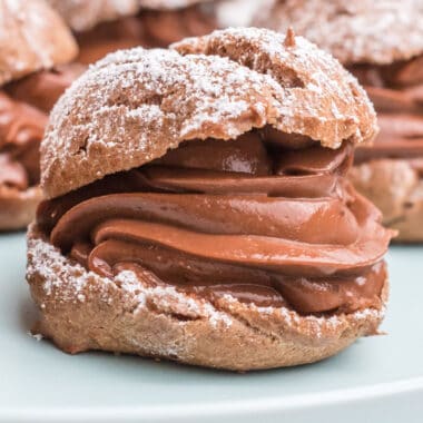 square image of a chocolate cream puff on a plate