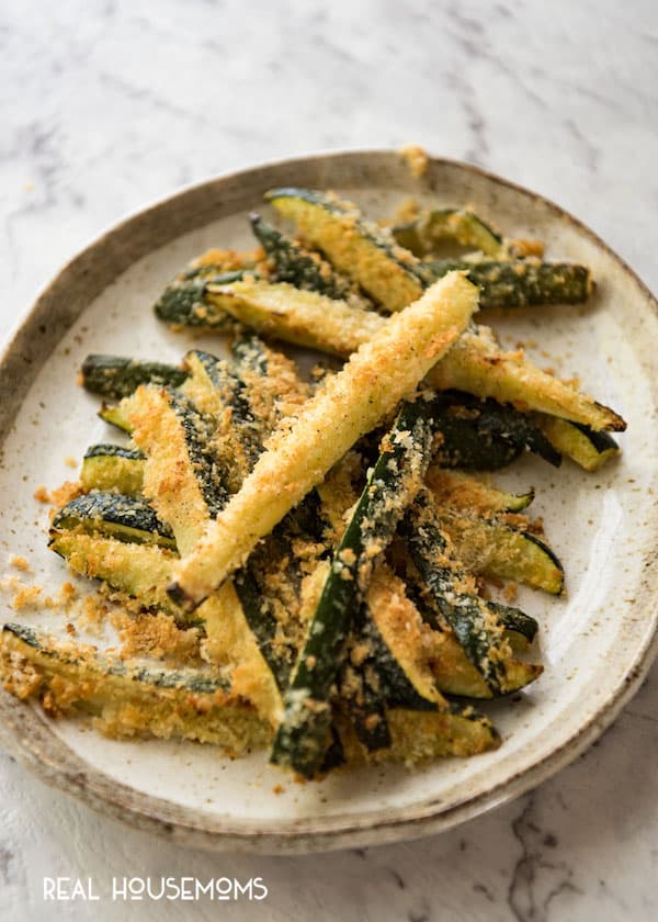 Finished Super Easy Parmesan Crust Zucchini piled up on a plate.
