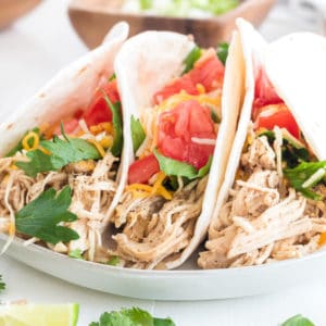 Super Easy Slow Cooker Chicken Tacos are the perfect weeknight meal! Let your crockpot do the hard work, then assemble your tacos and dig in!
