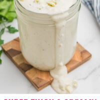 blue cheese dressing in a mason jar with a spoon with recipe name at the bottom