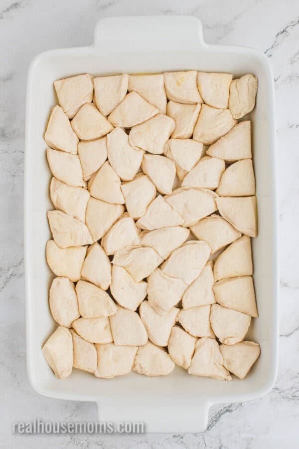 canned biscuit pieces in a baking dish