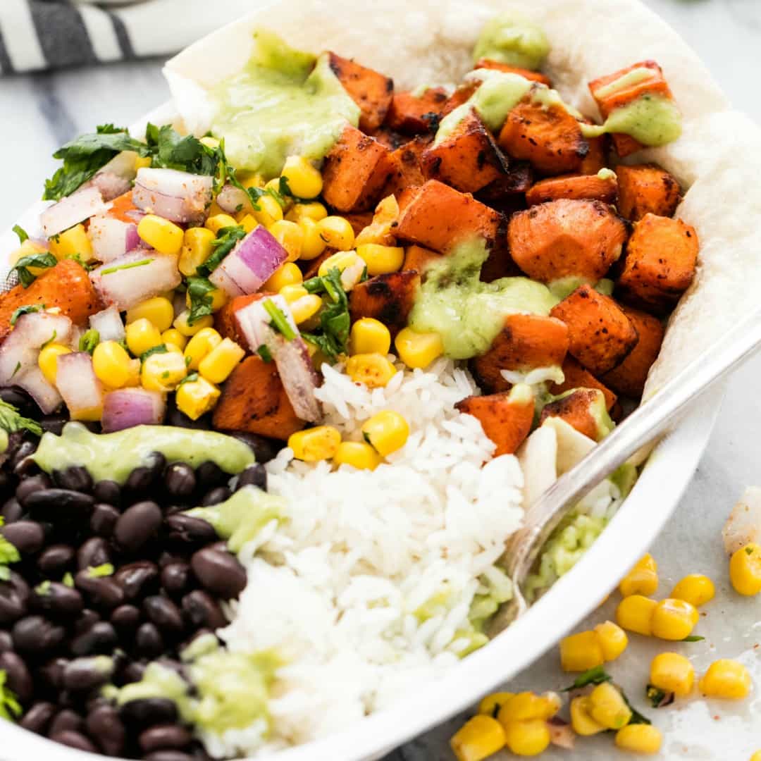 Easy and healthy sweet potato burrito bowls are full of fresh veggies and bold Tex-Mex flavors the whole family will love!