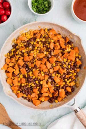 sweet potato, black bean, and corn filling for enchiladas in a large skillet