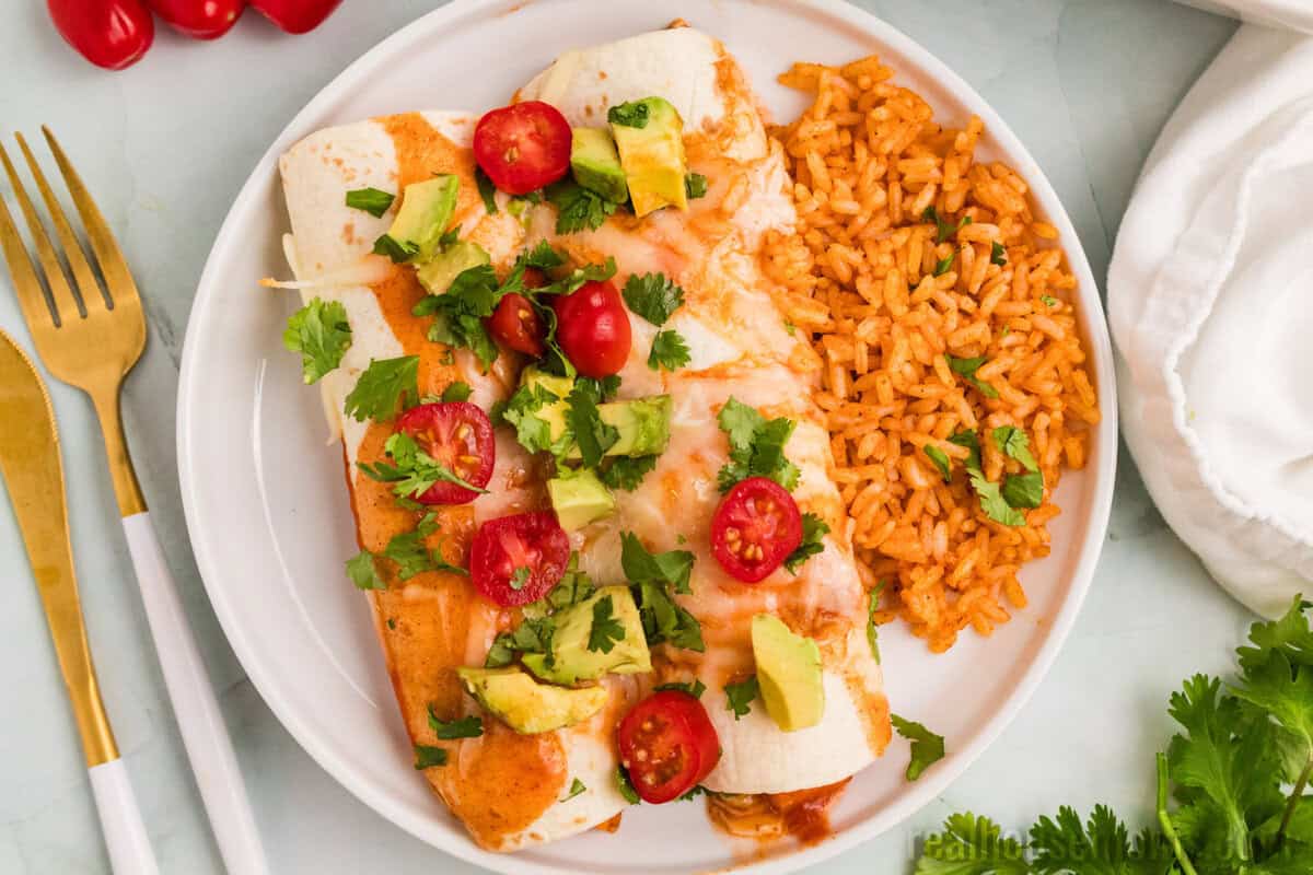 sweet potato black bean enchiladas on a plate with mexican rice