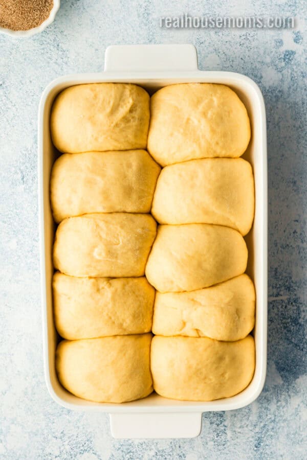 sweet potato dinner roll dough balls in a baking dish after rising again