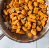 sweet potato gnocchi in a skillet with sage and brown butter with recipe name at the bottom