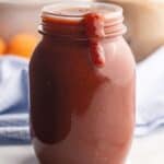 square image of sweet and tangy barbecue sauce in a jar