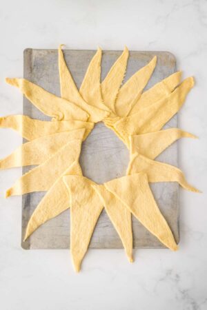 crescent roll dough laid out in a sun shape for taco crescent roll ring