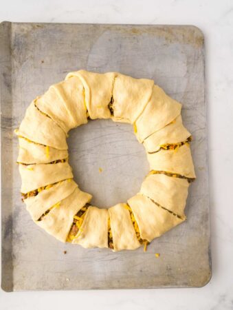crescent roll dough wrapped around taco meat and cheese for taco crescent roll ring