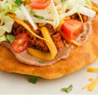 close up of taco fry bread with recipe name at the bottom