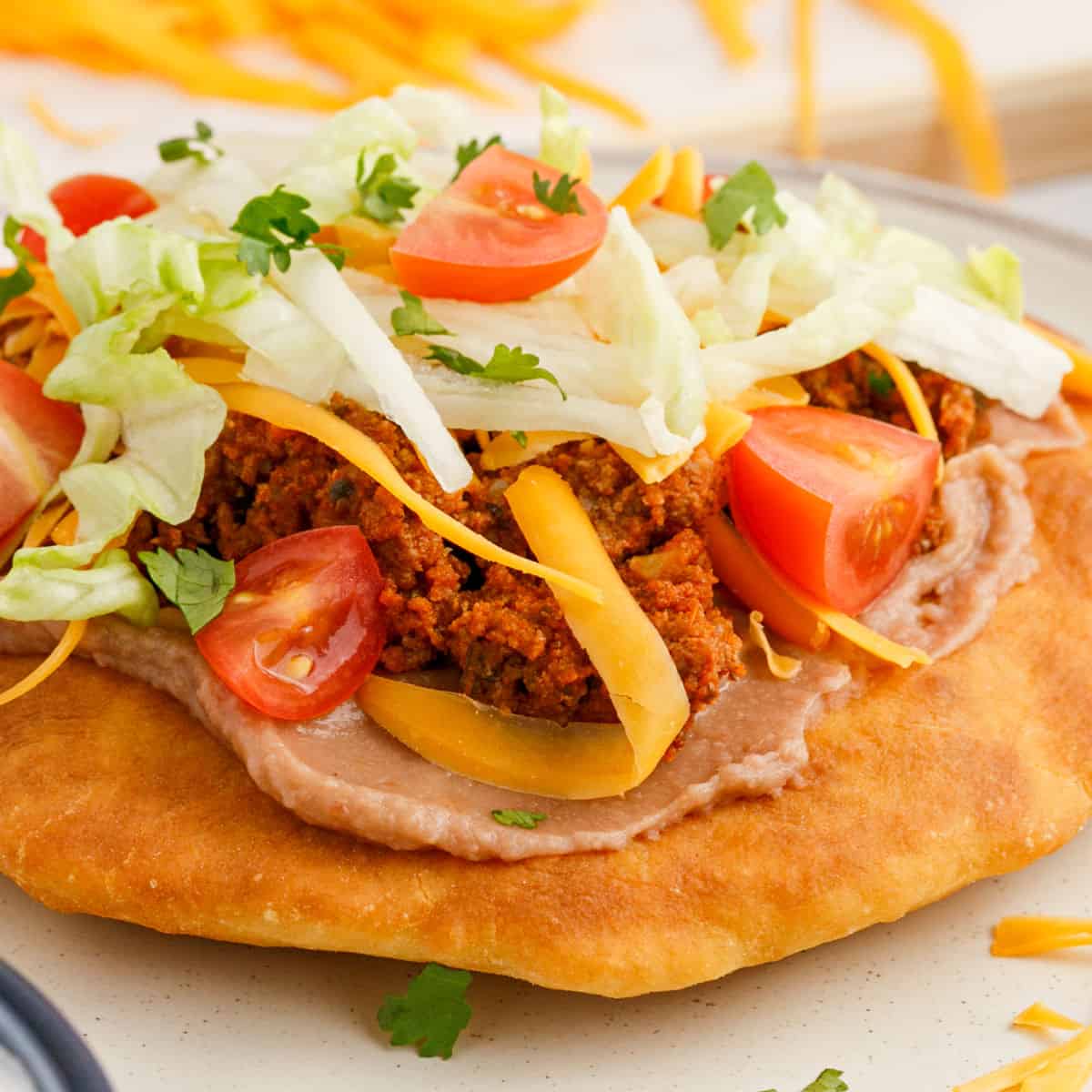 square close up image of a taco fry bread