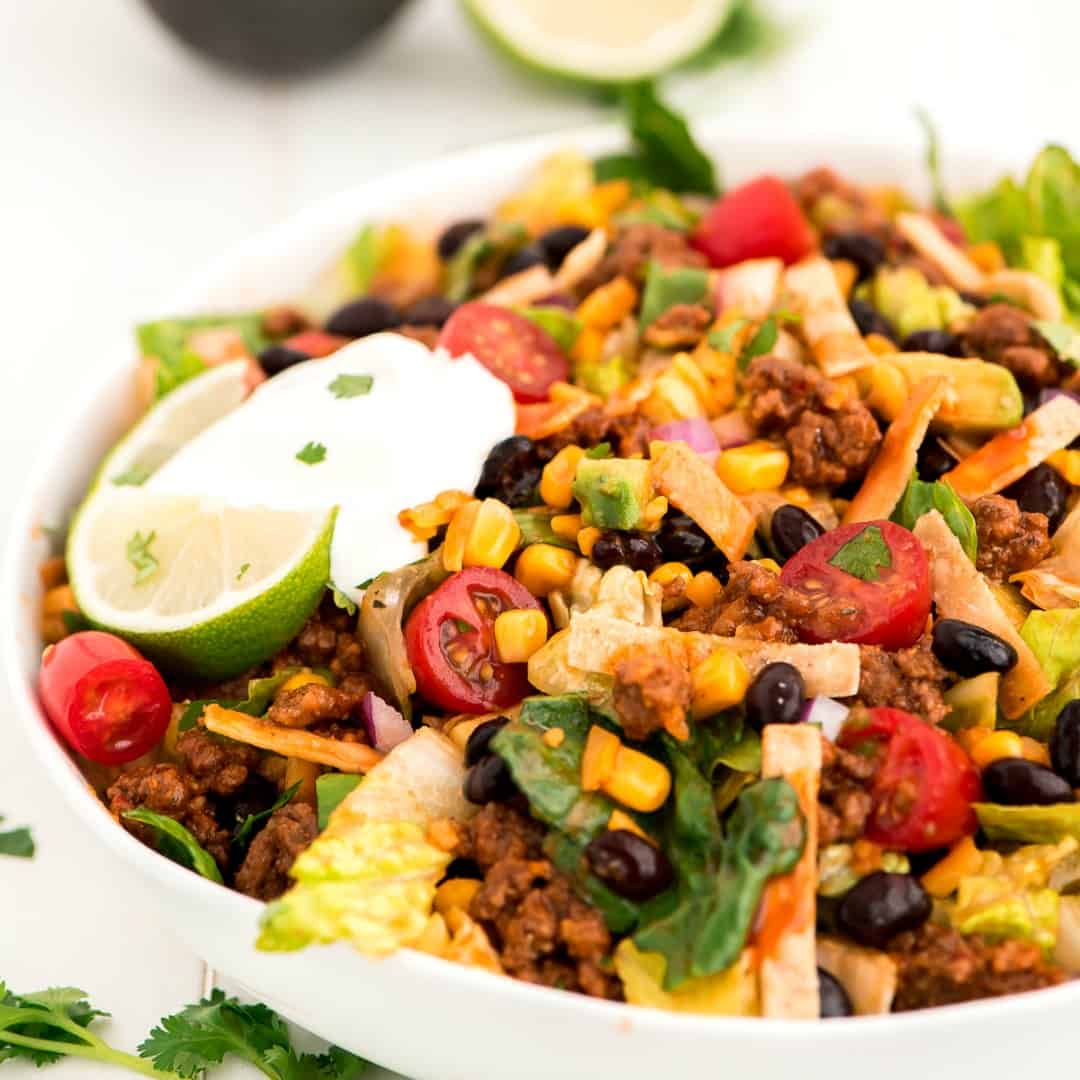 Taco Salad is a summer staple at our house. This easy meal is full everything your favorite tacos while helping you get in more greens!