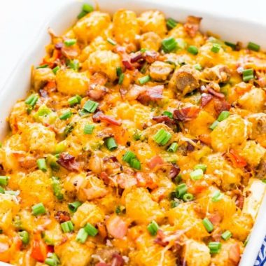 Tater Tot Breakfast Casserole in a baking dish topped with green onion and ready to be served