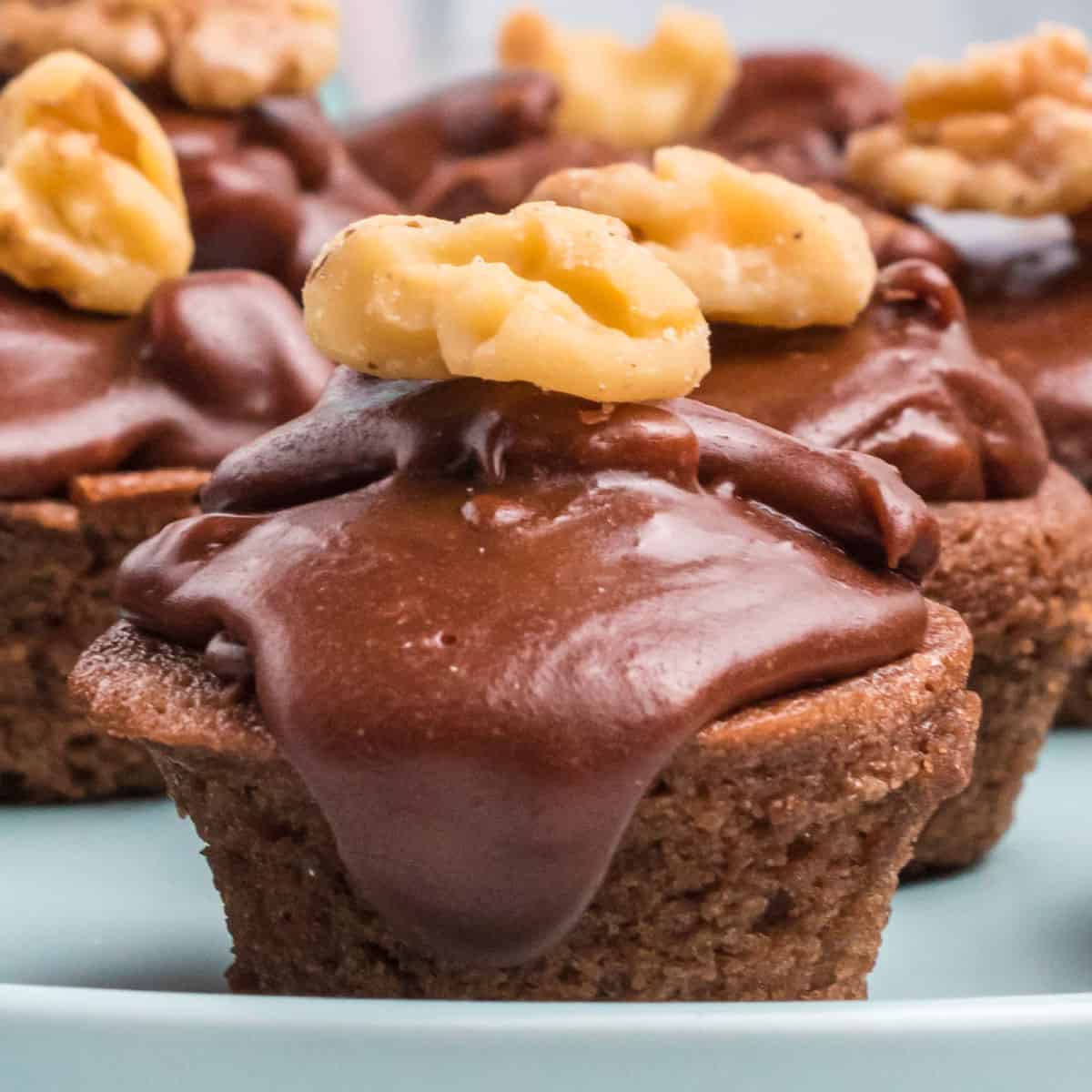 close up of a Texas sheet cake bites topped with a walnut