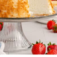 angel food cake with a slice taken out with strawberries on top with recipe name at the bottom