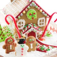 square image of a decorated gingerbread house with gingerbread people out front