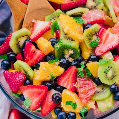 Bold, beautiful, and delicious are only a few ways to describe The Best Fruit Salad Recipe you will make.  The flavors of all the fruit mixed with fresh mint and sprinkled with a little brown sugar are sensational!