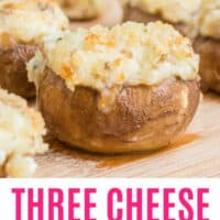 three cheese stuffed mushrooms on a wooden board with recipe name at the bottom