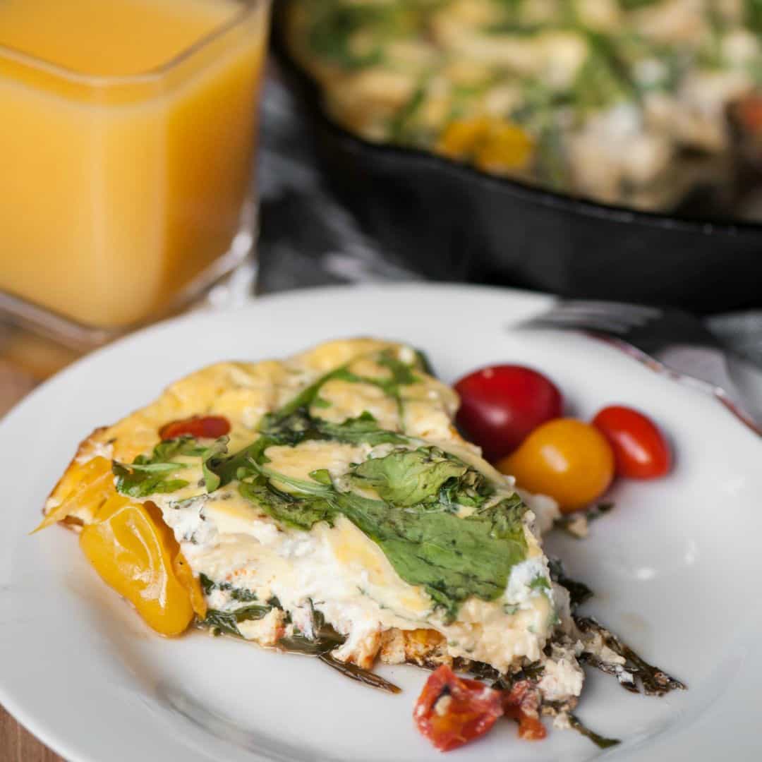 Start your morning off right with this flavorful and healthy protein packed Tomato Arugula Goat Cheese Frittata made with eggs and fresh veggies!