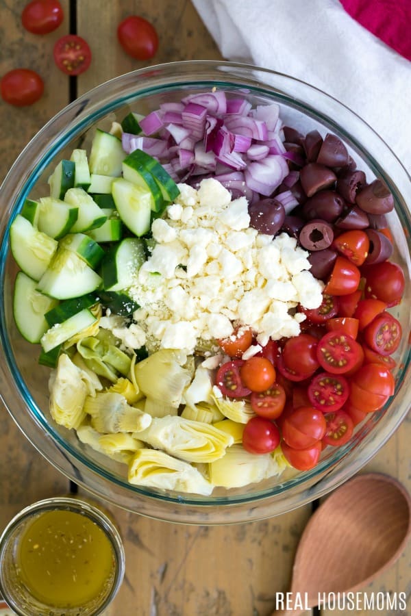 ingredients for tortellini pasta salad in a mixing bowl
