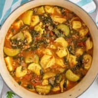 square image of tortellini soup in a large pot