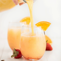 Tropical Orange Punch is the ultimate refreshing summer drink! Cool down at your summer parties with a glass of this delicious citrus drink!
