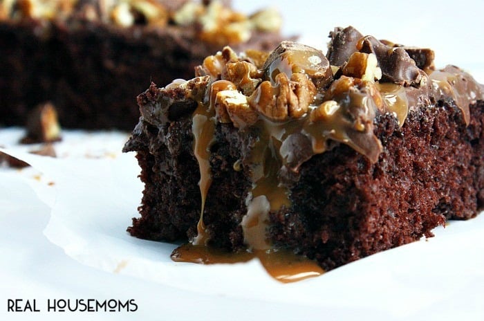 This TURTLE POKE CAKE is a rich chocolate cake soaked in caramel sauce, and covered in chocolate frosting, pecans & more caramel!