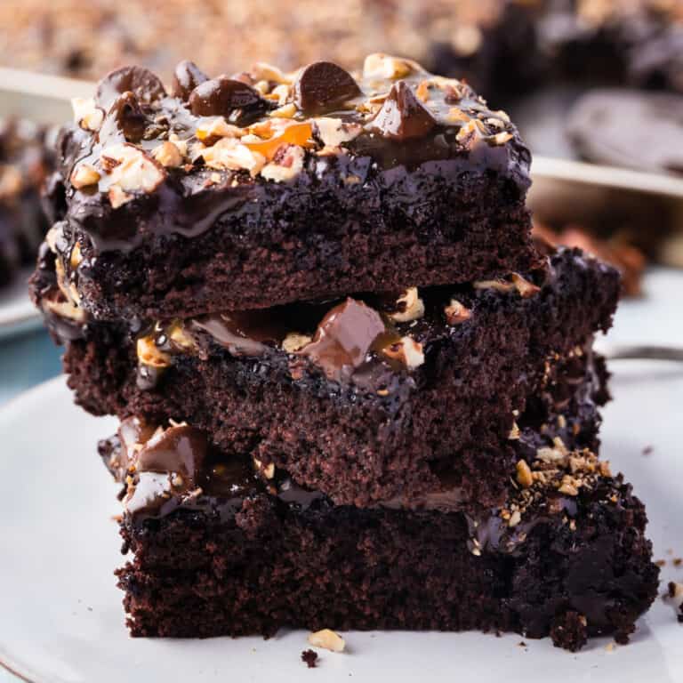 square image of 3 slices of texas turtle sheet cake stacked on a plate