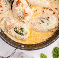 skillet of creamy tuscan chicken with recipe name at the bottom