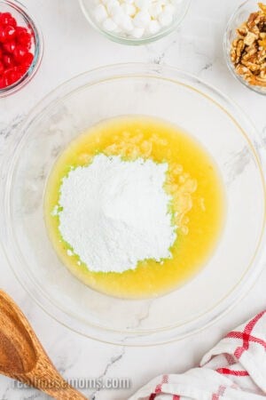 crushed pineapple, juice, and pistachio pudding mix in a mixing bowl