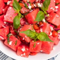 looking down at a bowl of watermelon salad with recipe name at bottom