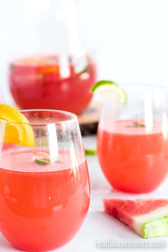Watermelon Sangria Recipe in three glasses with a slice of watermelon on the counter