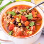 square image of weight watchers taco soup in a bowl with a spoon and parsley