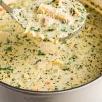 ladleful for white chicken lasagna soup over a pot with recipe name at bottom