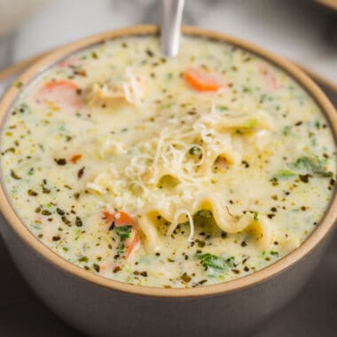 square image of a bowl of white chicken lasagna soup with a spoon