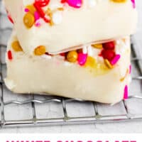 two pieces of white chocolate fudge stacked up with recipe name at the bottom