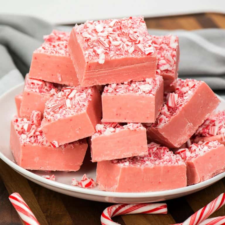 White Chocolate Peppermint Fudge is a super easy recipe that tastes out of this world good! Creamy white chocolate mixed with peppermint is always a hit at Christmas!