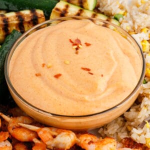 square image of a bowl of yum yum sauce with chili flakes on top
