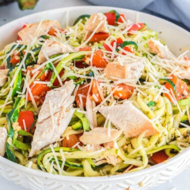 square image of a bowl of zoodles with chicken and cheese