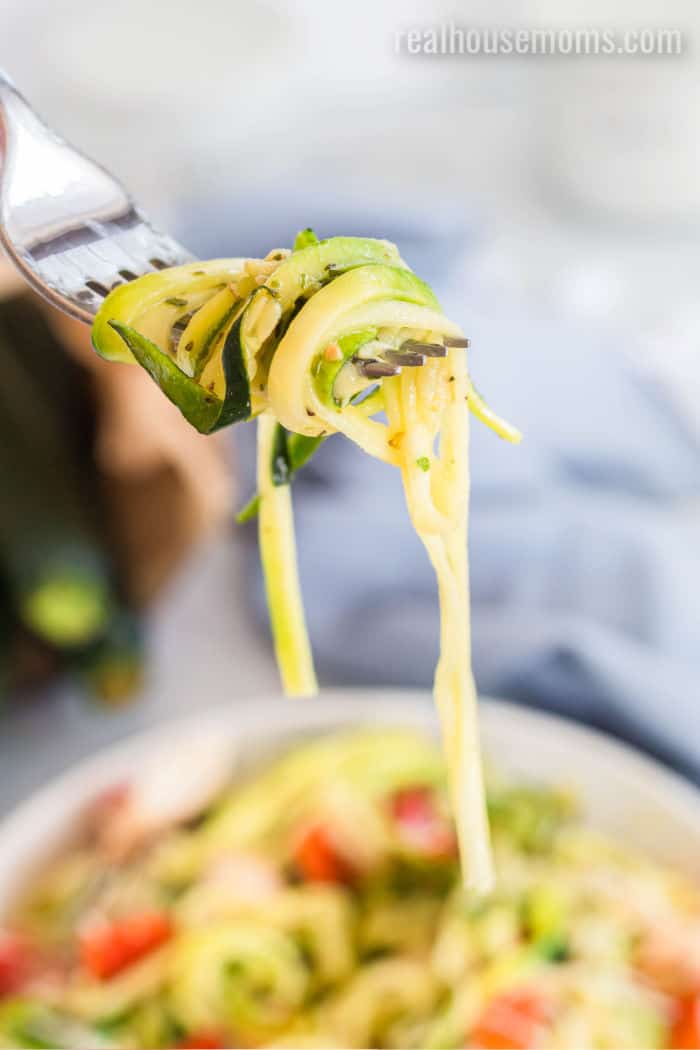 fork with zucchini noodles twirled around it.