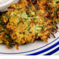 zucchini fritters on a plate with greek yogurt ranch with recipe name at the bottom