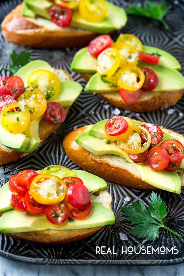 Avocado toast is not just for breakfast anymore! These AVOCADO CROSTINI are topped with a tomato and herb relish and are the perfect simple appetizer for any occasion!