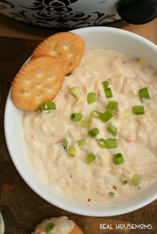 This cheesy CROCK POT SHRIMP AND ARITCHOKE DIP is hot, creamy, and full of tender shrimp. It's sure to be the hit of your next get-together!