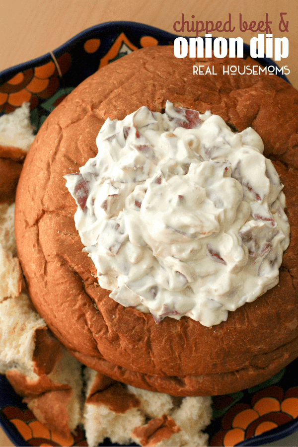 CHIPPED BEEF AND ONION DIP, served in a bread bowl, is a creamy hot dip that is full of thinly sliced beef and golden caramelized onions. It's the perfect dip for a party!