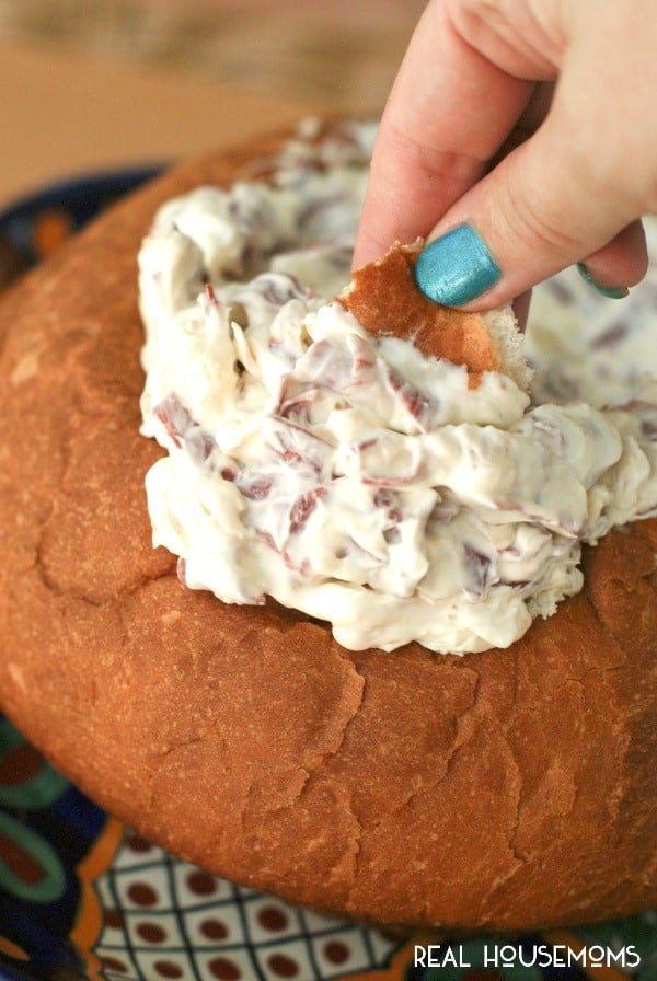 CHIPPED BEEF AND ONION DIP, served in a bread bowl, is a creamy hot dip that is full of thinly sliced beef and golden caramelized onions. It's the perfect dip for a party!