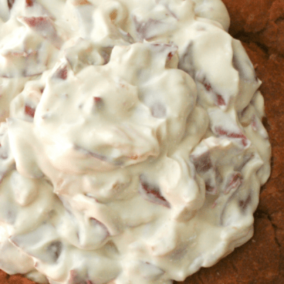 CHIPPED BEEF AND ONION DIP, served in a bread bowl, is a creamy hot dip that is full of thinly sliced beef and golden caramelized onions. It's the perfect dip for a party!