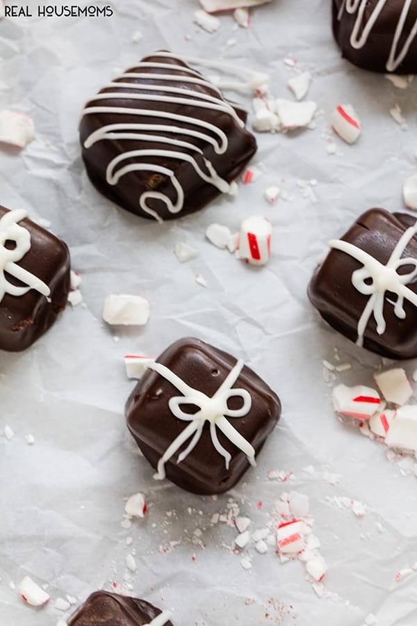 Chocolate Covered Caramels coated in chocolate candy and drizzled with white chocolate candy to make designs
